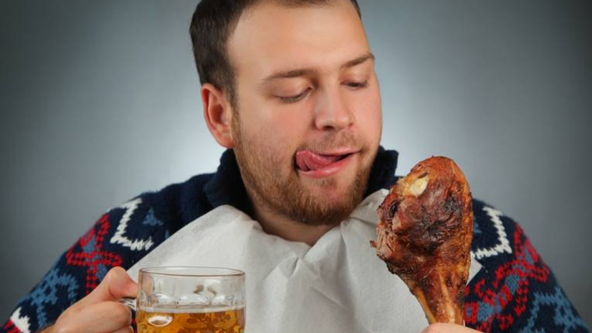 man eating turkey drinking beer